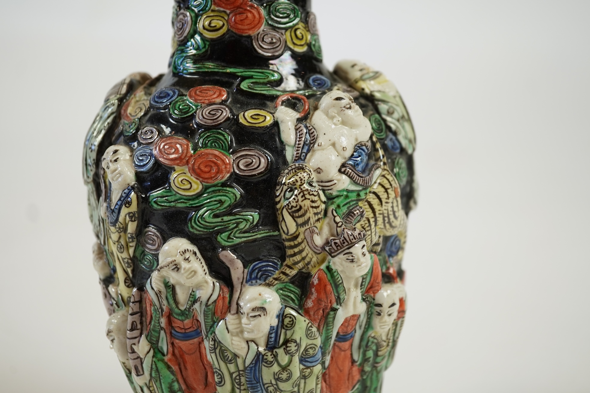 A Chinese enamelled biscuit ‘eighteen Luohan’ vase, 19th century